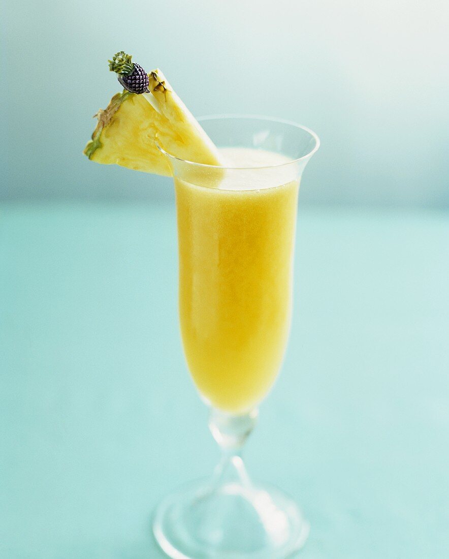 A champagne cocktail with mango and pineapple