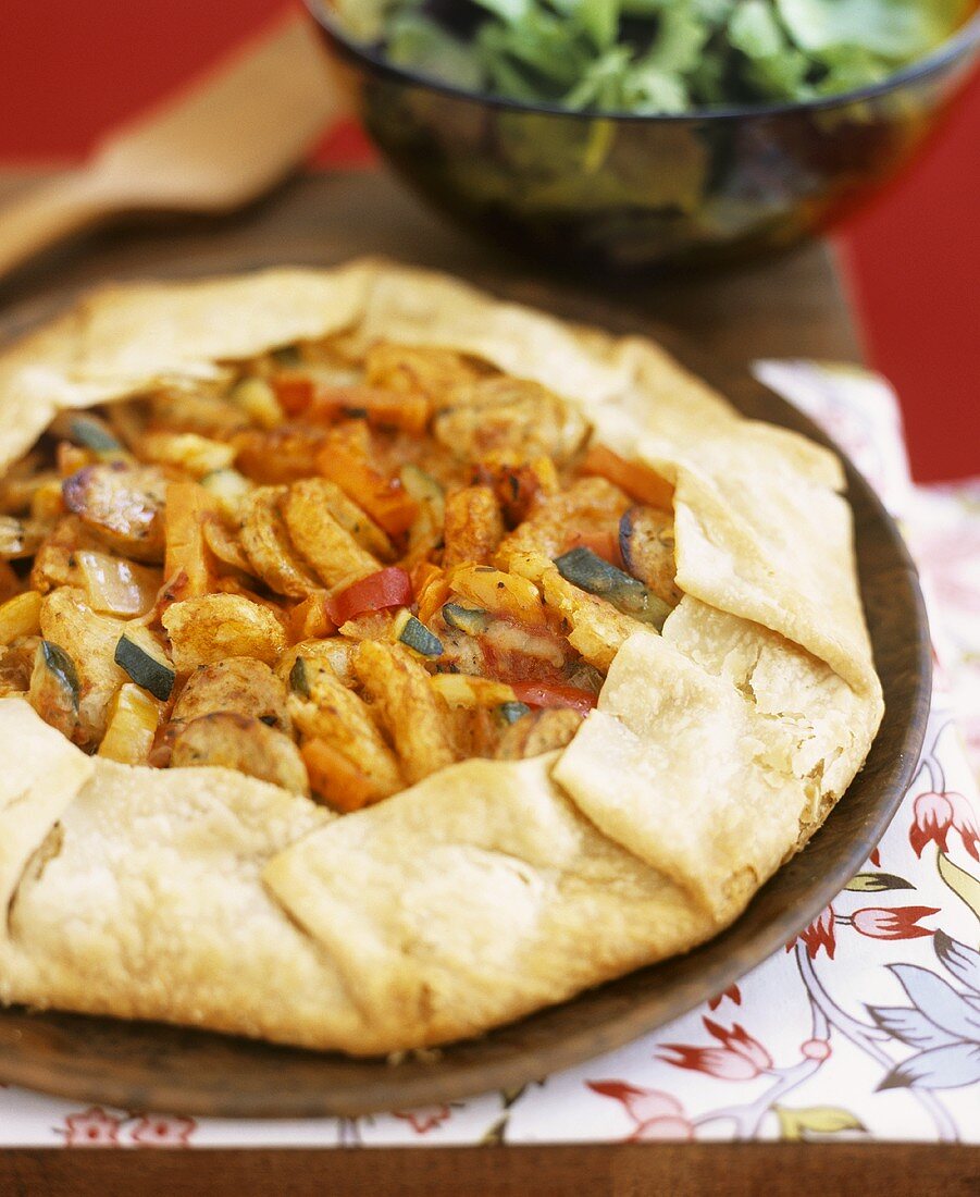 Galette filled with vegetables and sliced sausage