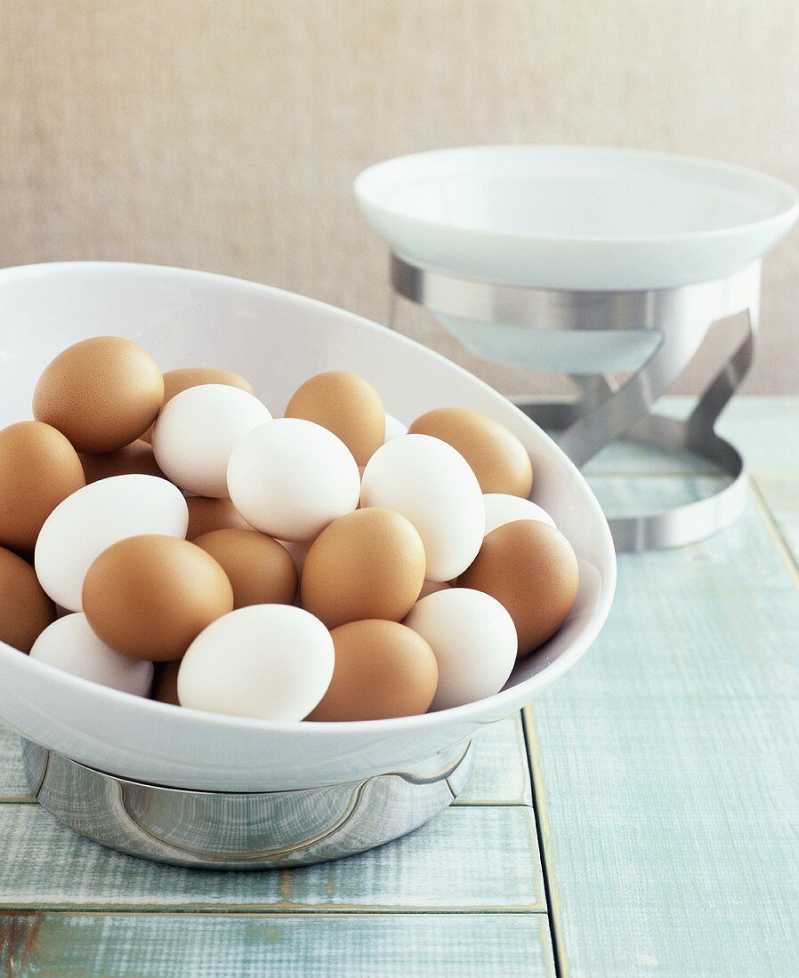 White and brown hard-boiled eggs in a bowl