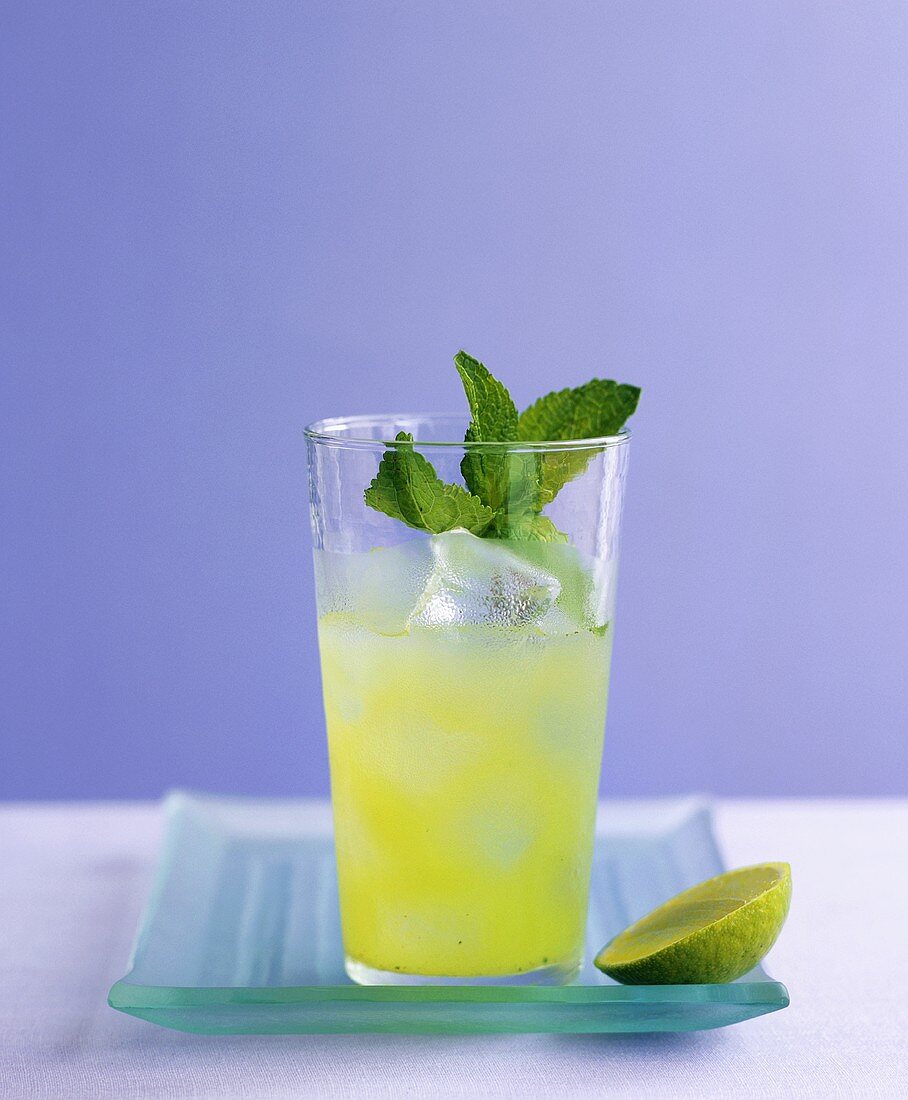 Refreshing cocktail with cucumber, mint and ice cubes