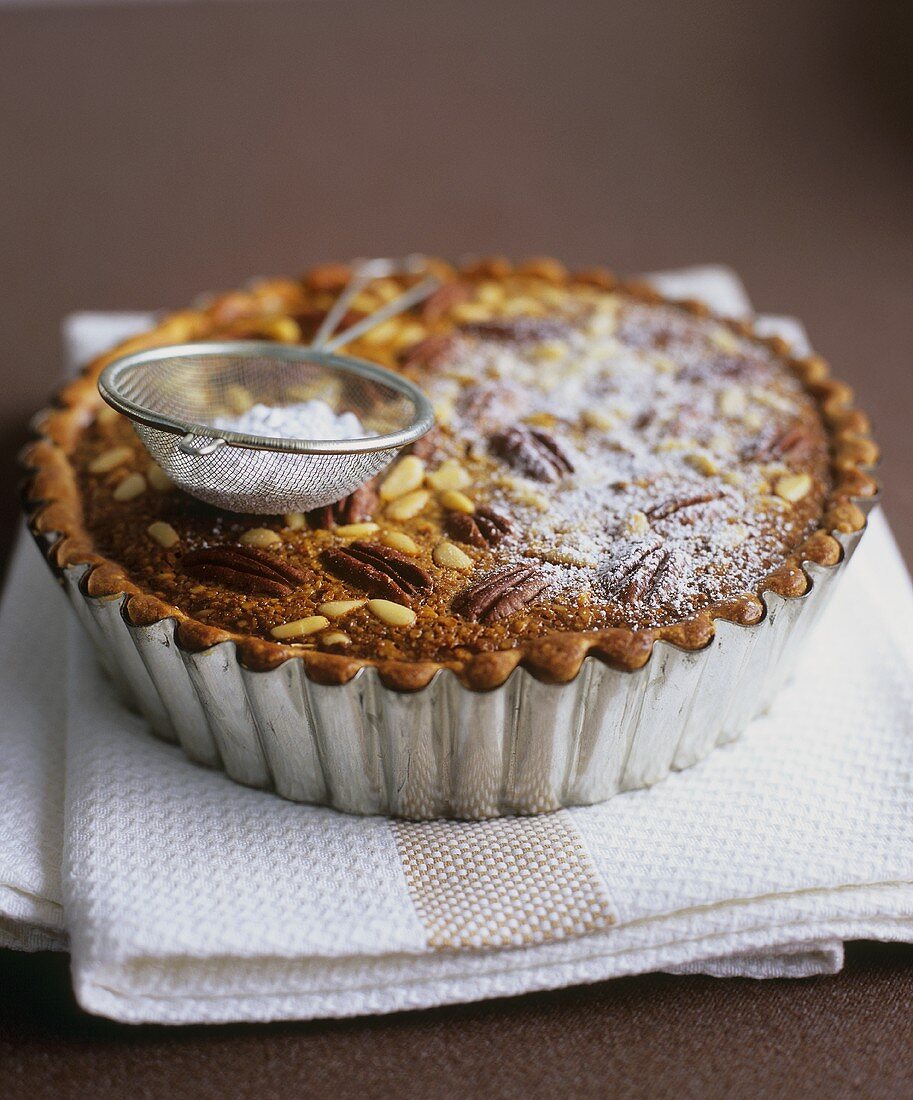 Pecan and pine nut tart with treacle