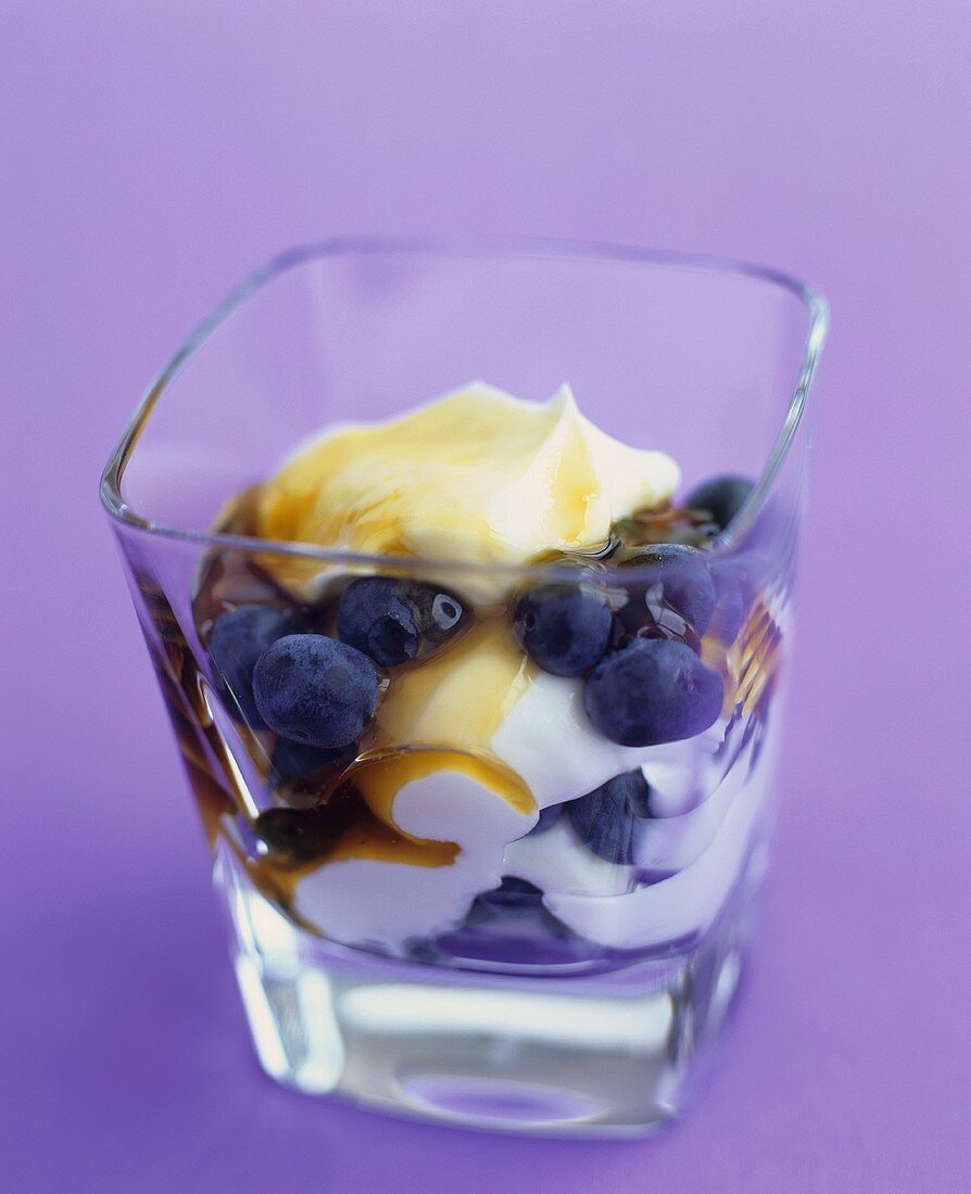 Yoghurt with honey and blueberries in a glass