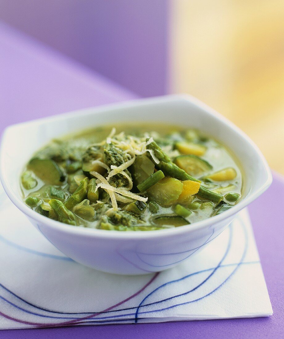 Spring vegetable soup with cheese and pesto