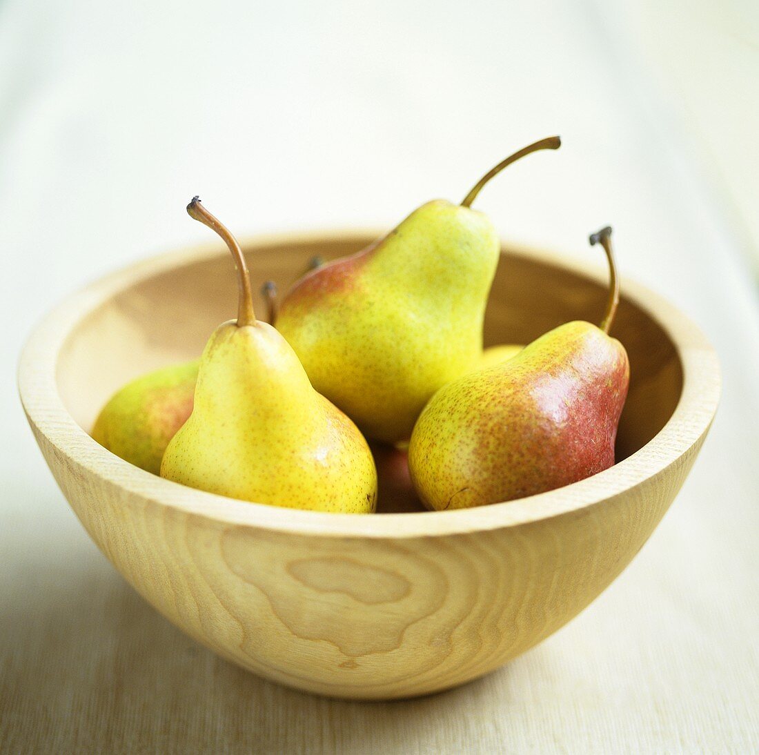 Several pears in a wooden bowl