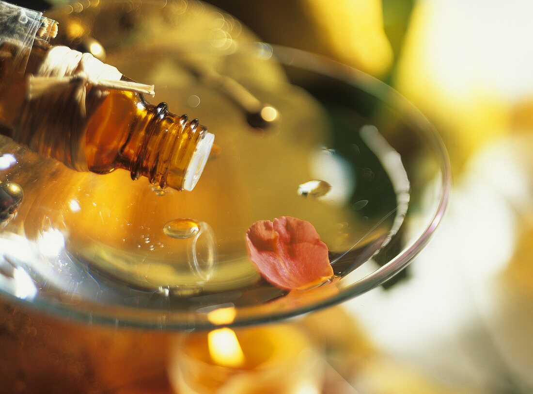 Dripping aromatic oil into the bowl of an aroma lamp