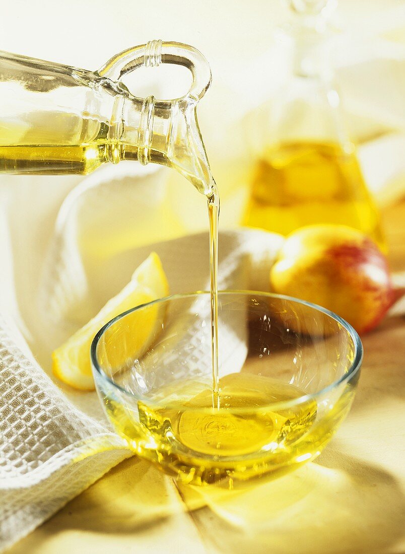 Plant oil being poured into a glass dish