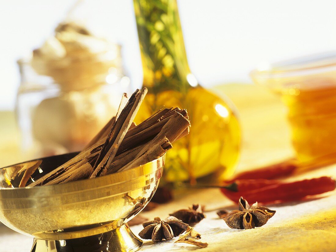 Still life with cinnamon sticks, star anise and chillies