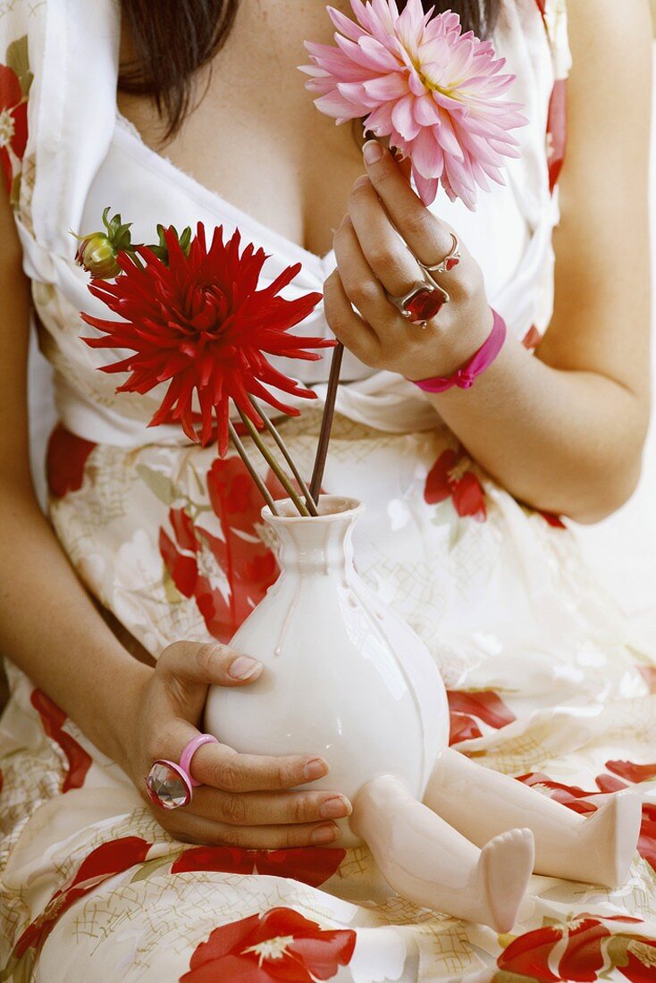 Woman holding flower in hand