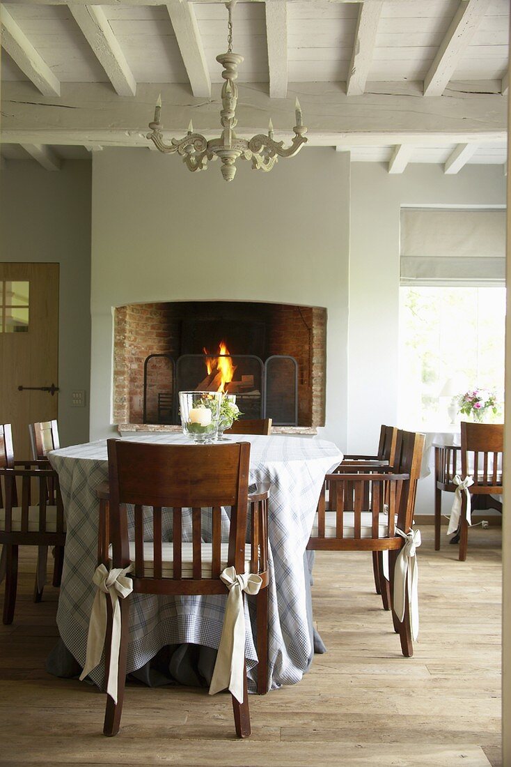 Ein Esstisch mit klassischer Tischdecke und elegante Holzstühle mit Schleifendekor