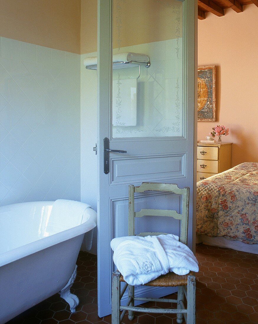 A bathroom with a view into a bedroom