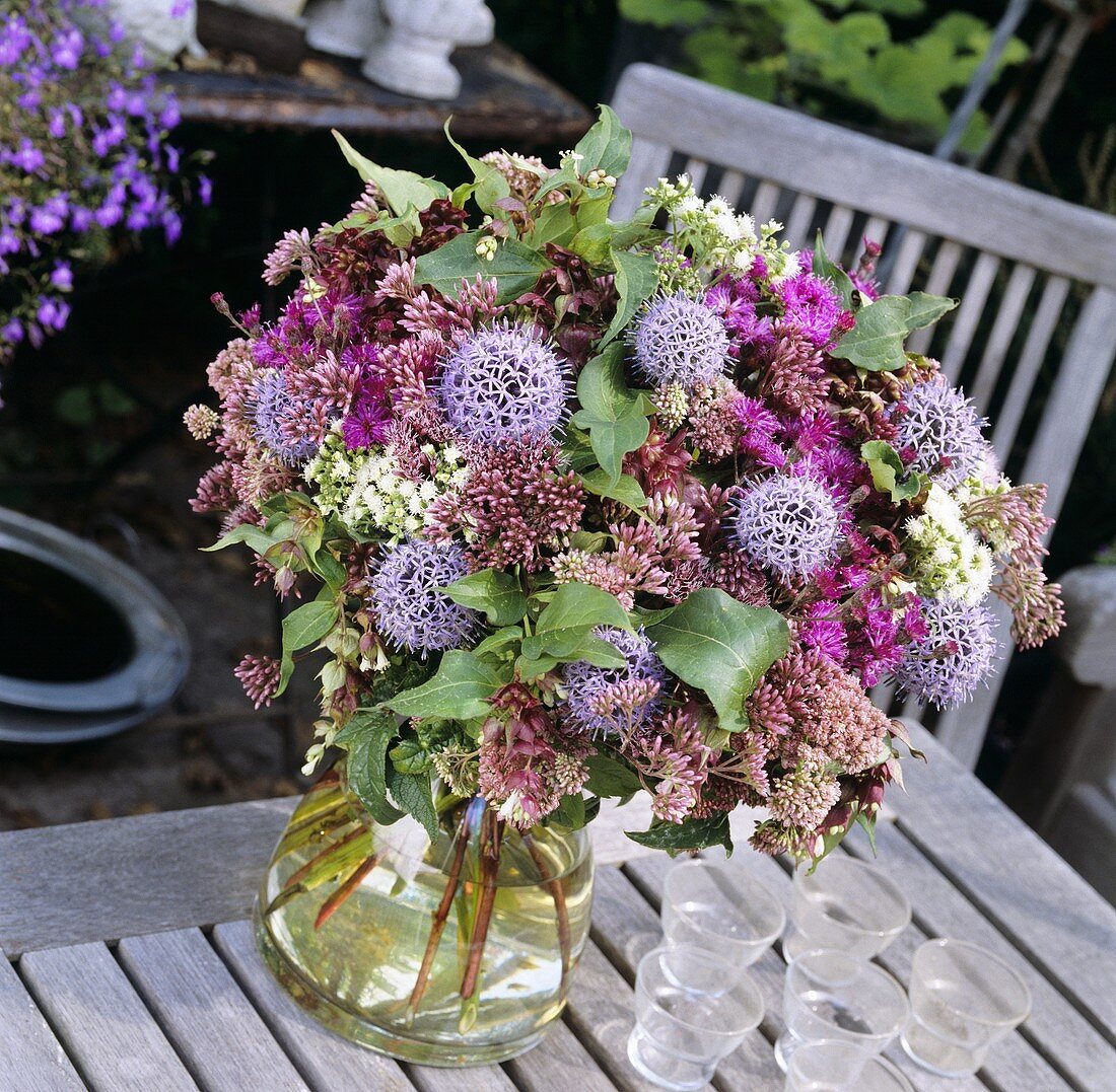 Vase of globe thistles and other flowers