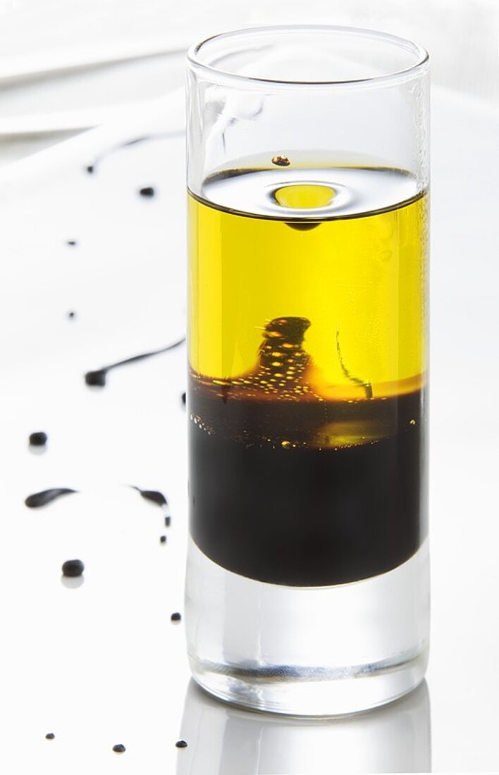 Balsamic vinegar and olive oil (vinaigrette) in a glass
