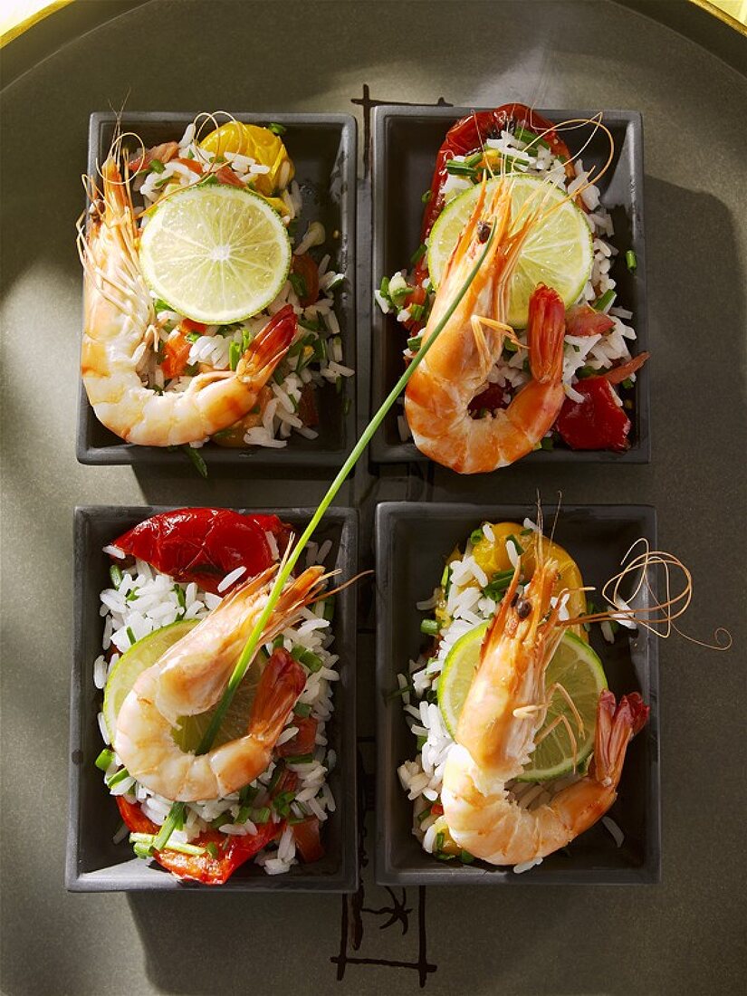 Four bowls of rice salad with red peppers and prawns