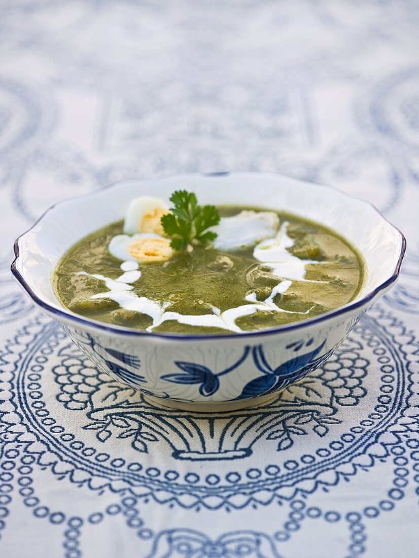 Coriander soup with fish and quail's egg