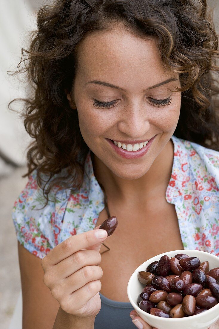 Woman eating olives