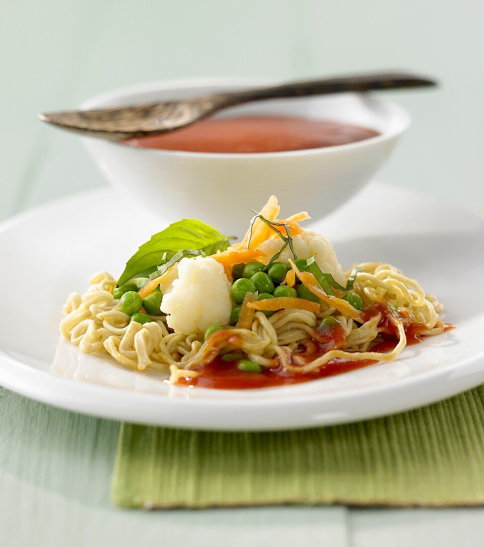 Fried Chinese egg noodles with vegetables and tomato sauce