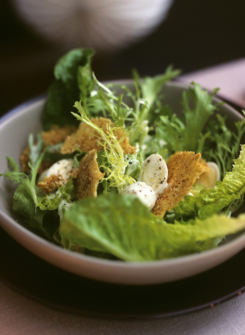 Caesar salad with quails' eggs and Parmesan sesame crisps