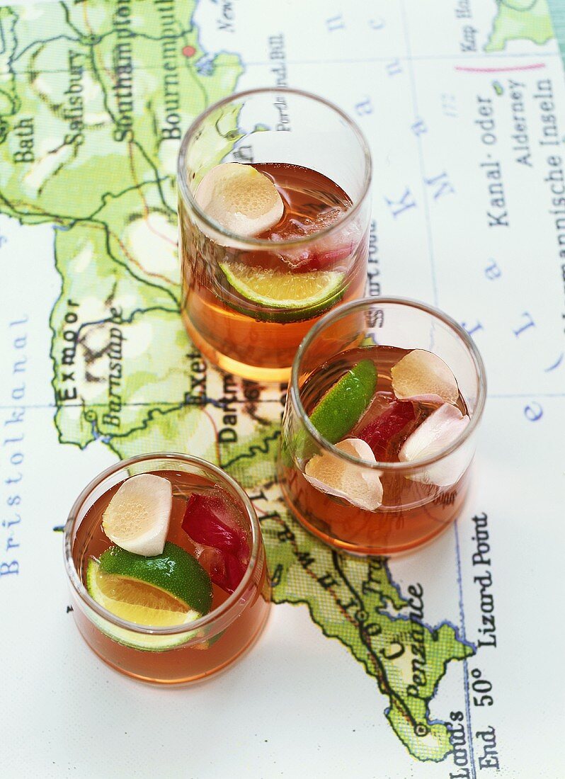 Three glasses of rose punch on a map