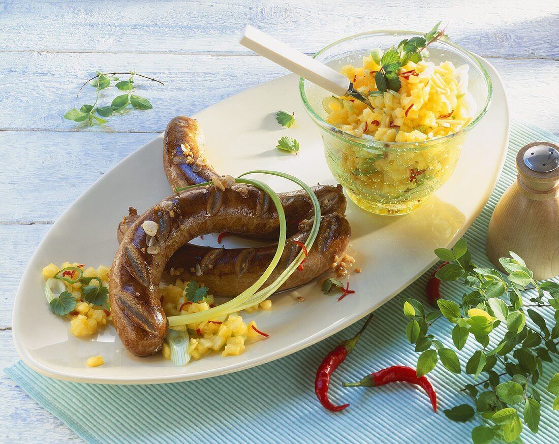Sausages with mango and chilli salad