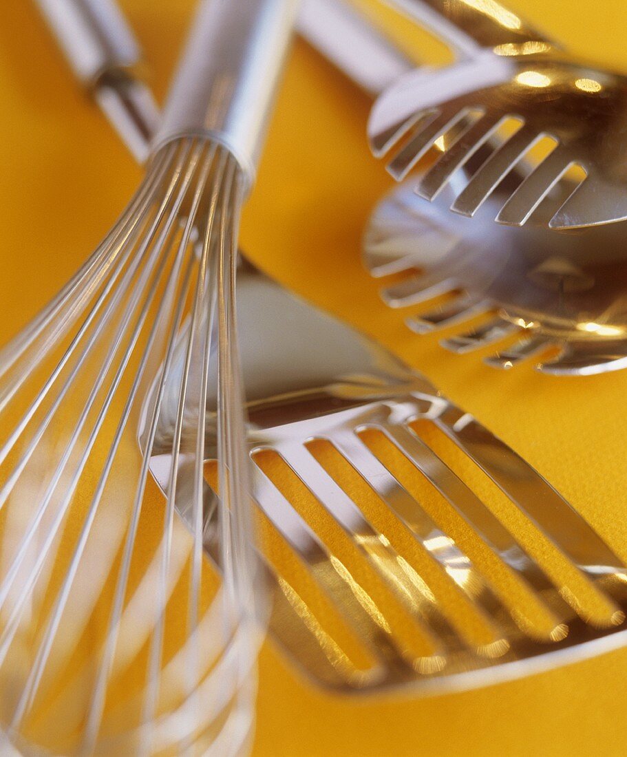 Kitchen utensils: whisk, spatula, pasta tongs