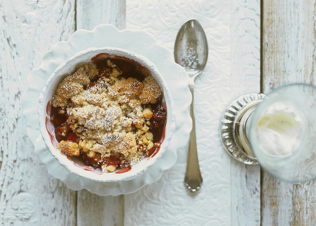 Apple and red wine crumble and a glass of vanilla cream