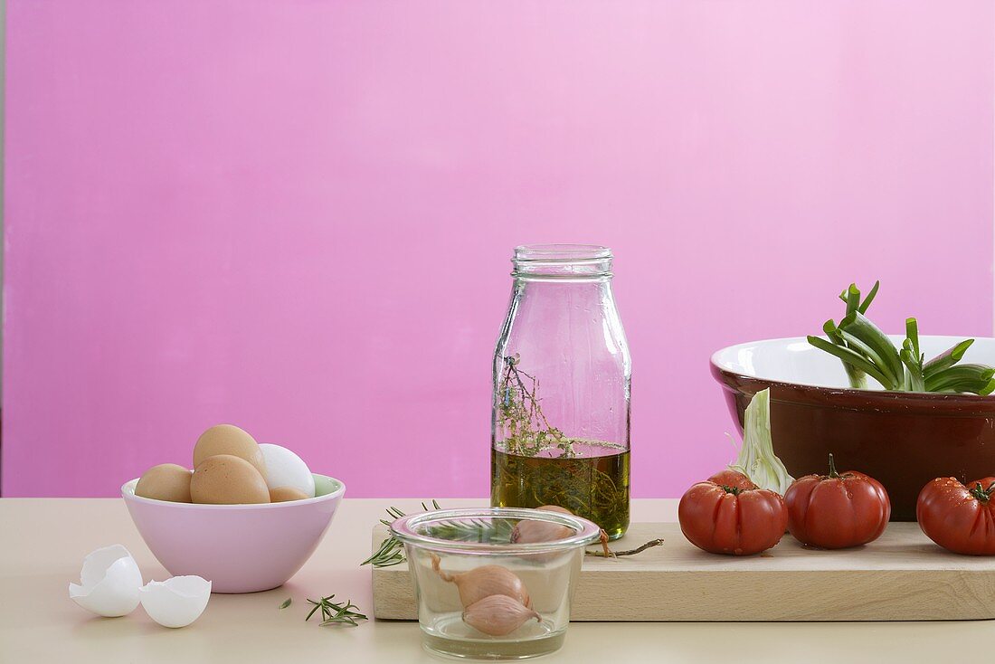 Still life with eggs, onions, herb oil and vegetables