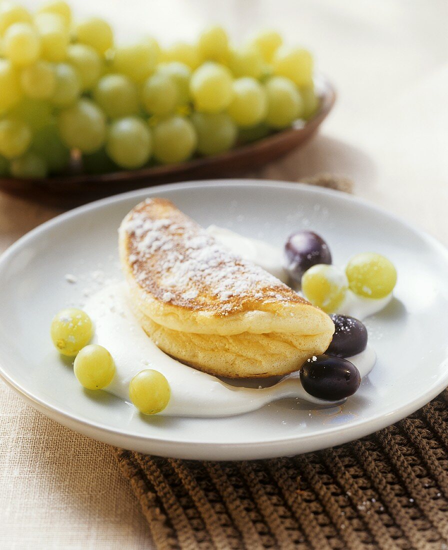 Sweet soufflé omelette with grapes and quince cream