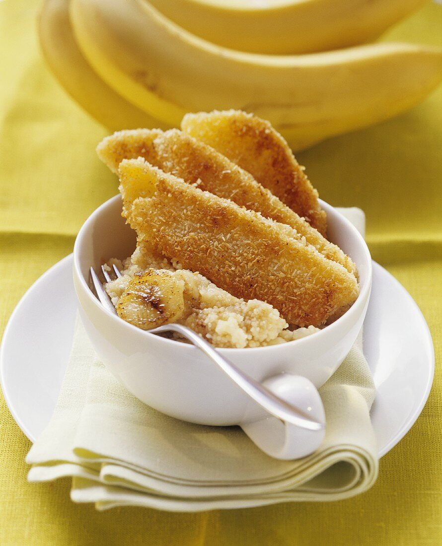 Fried coconut-coated mango slices on banana couscous