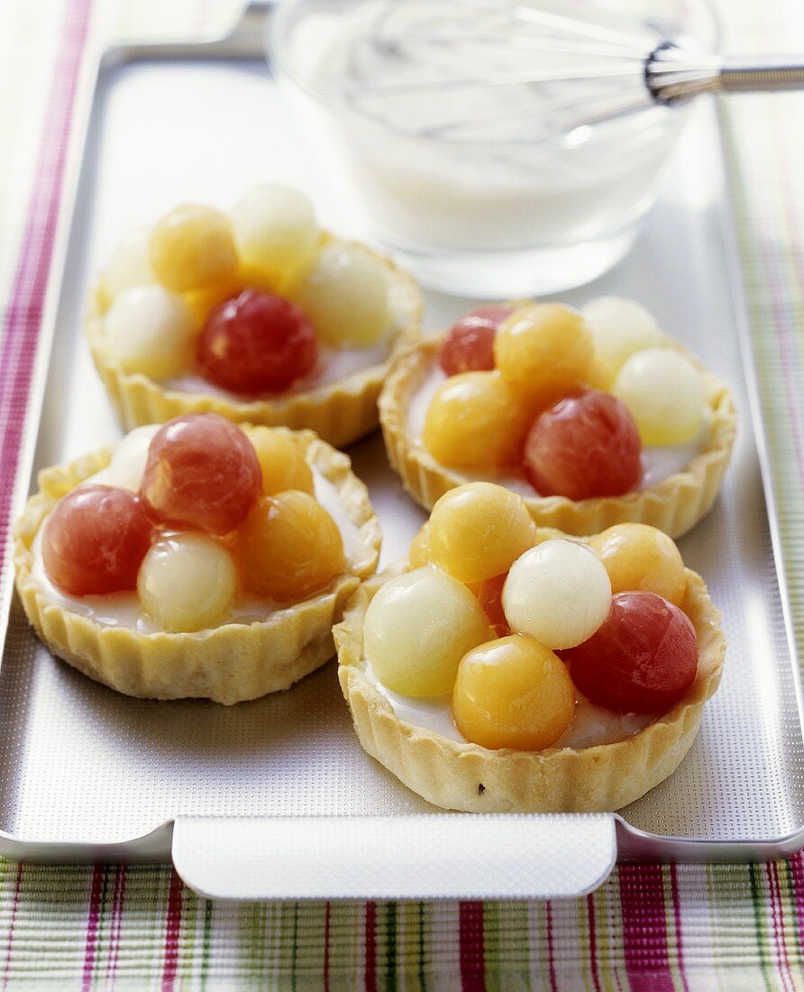 Melon tarts with melon balls and yoghurt cream