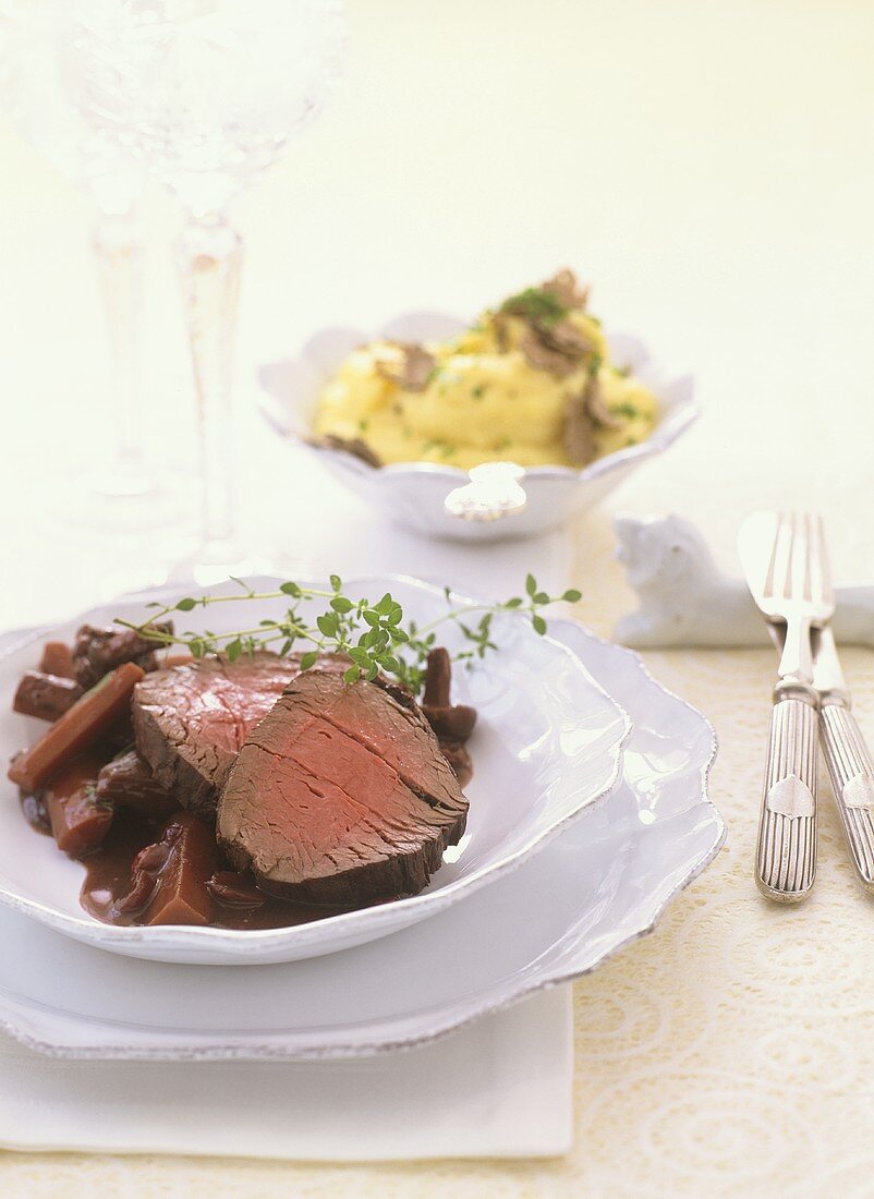 Beef fillet with carrots and mushrooms in red wine sauce