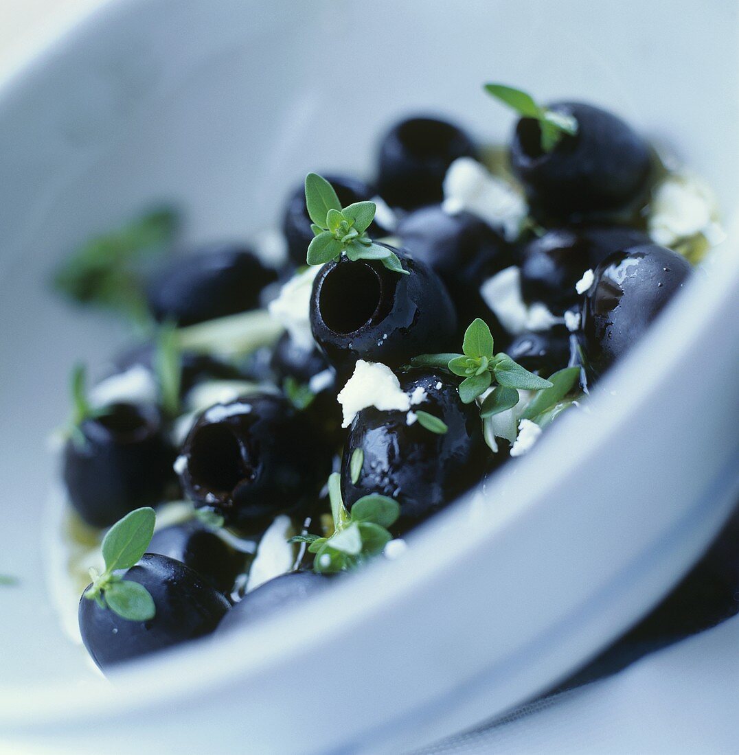 Stoned, black olives with thyme and feta cheese