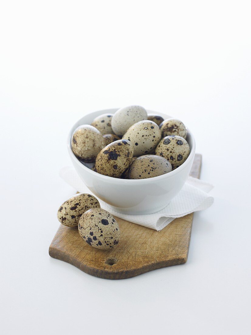 Quails' eggs in and beside a small bowl