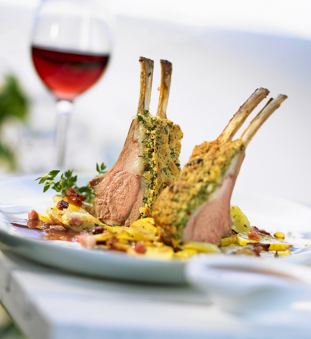 Rack of lamb in herb crust with fried potatoes & a glass of wine