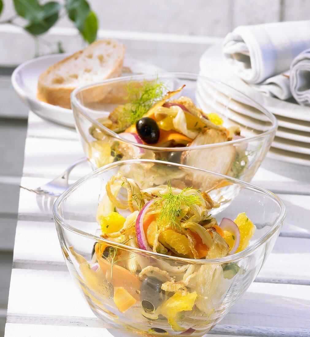 Two bowls of orange and fennel salad with olives and mint
