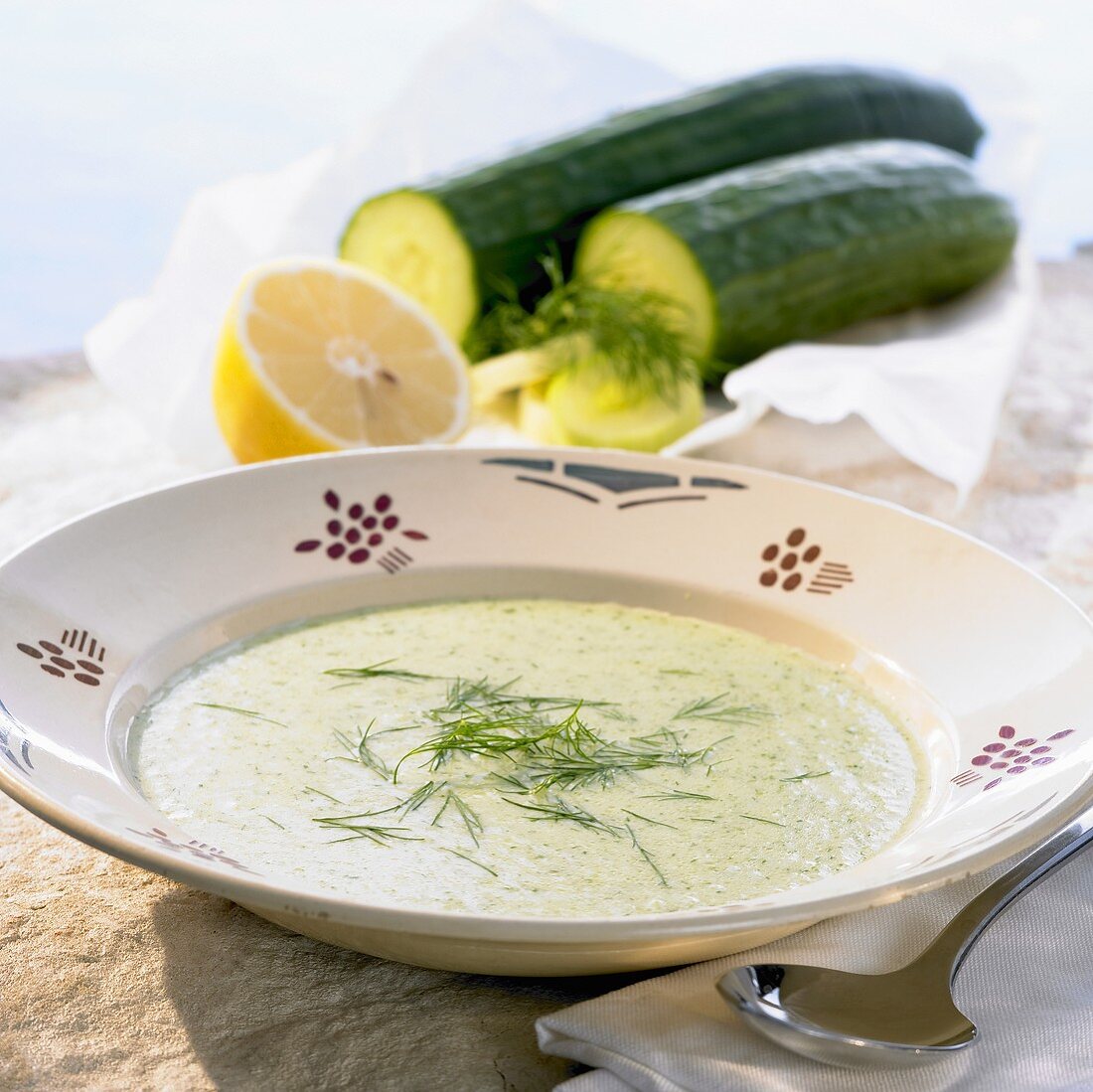 A plate of cold cream of cucumber soup with dill and lemon