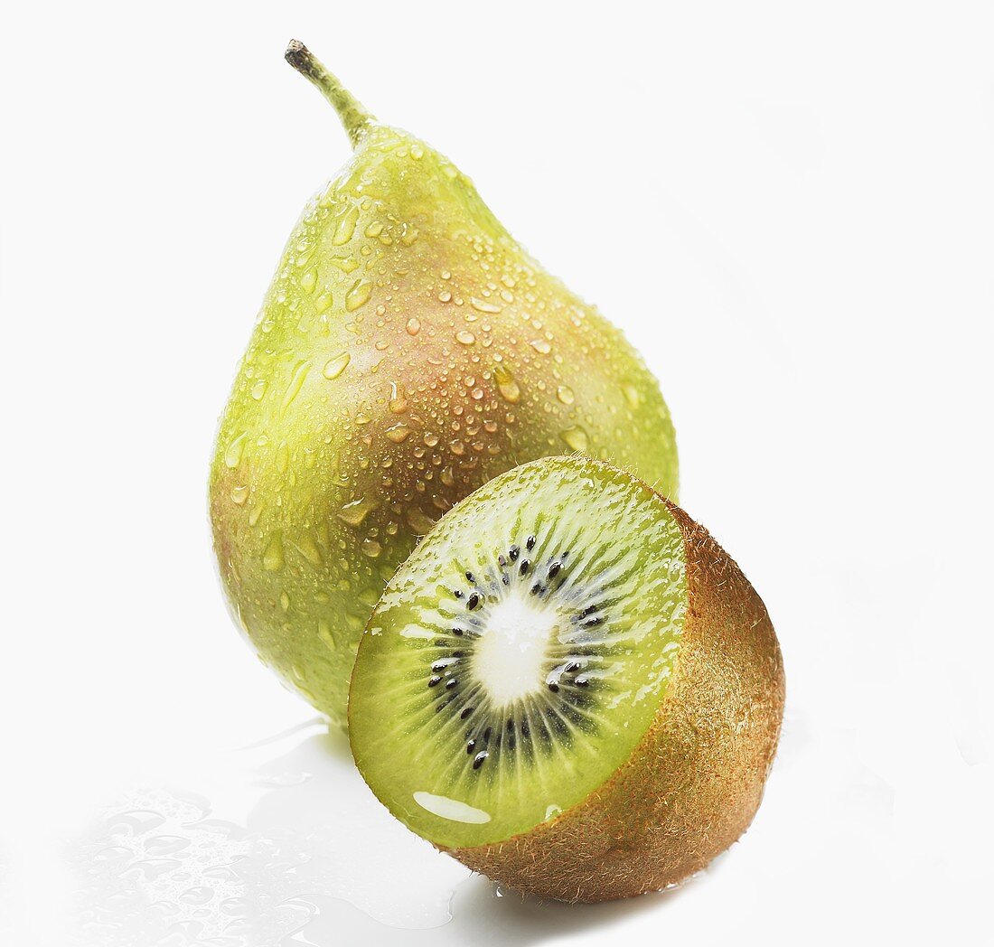 Pear with drops of water and half a kiwi fruit