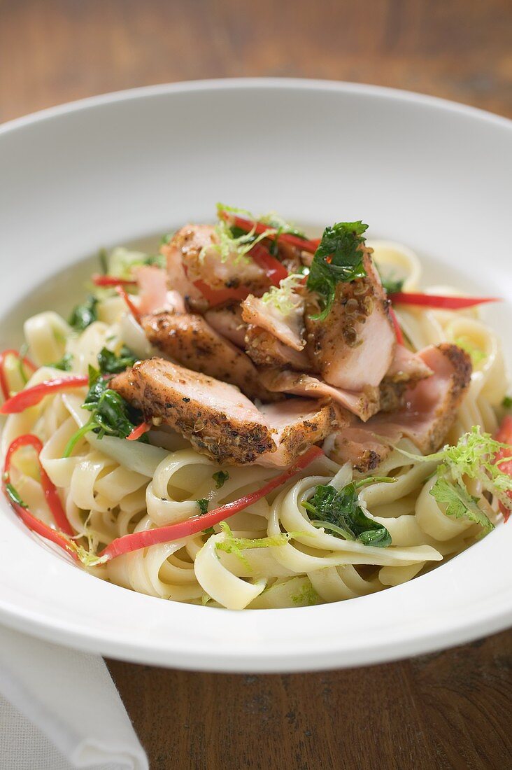 Ribbon pasta with fried peppered salmon and red pepper