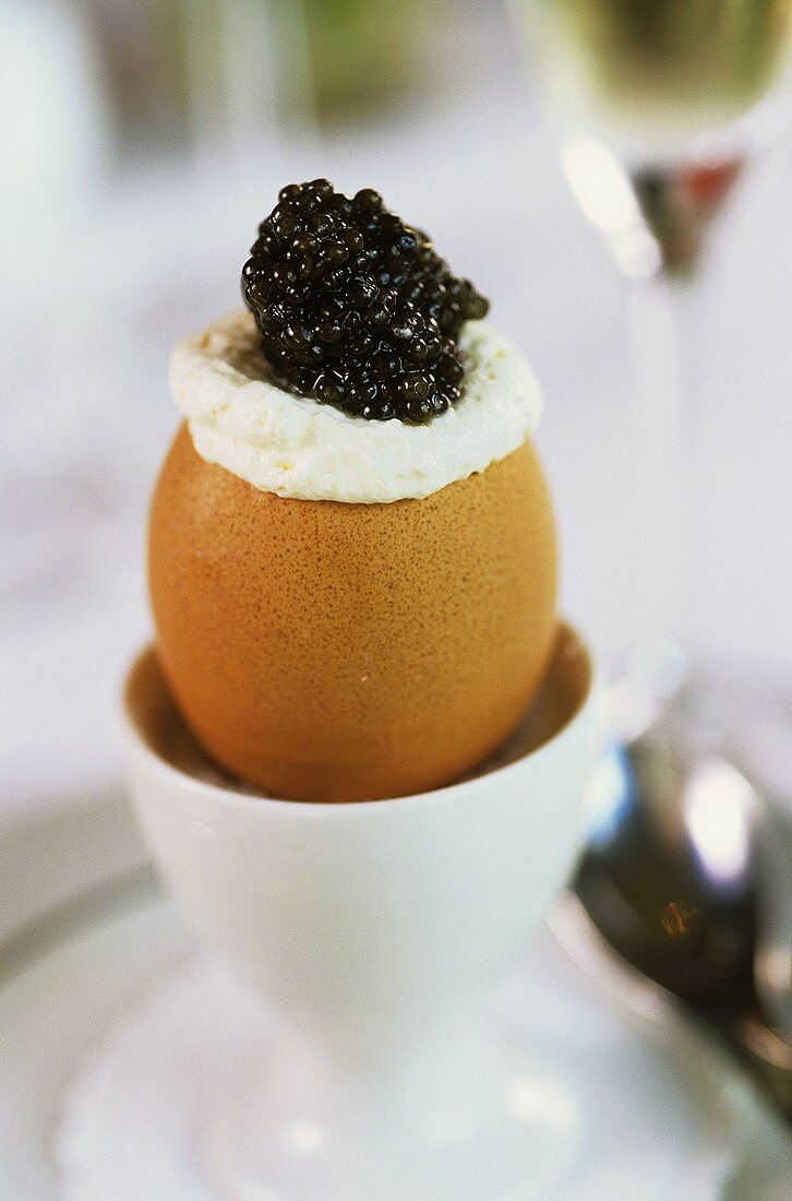 Boiled egg in its shell with caviar