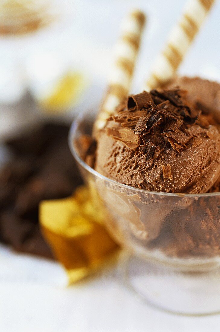 Several scoops of chocolate ice cream in a sundae glass