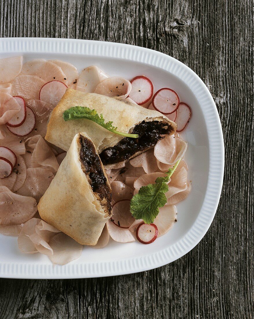 Venison strudel on pink radish salad