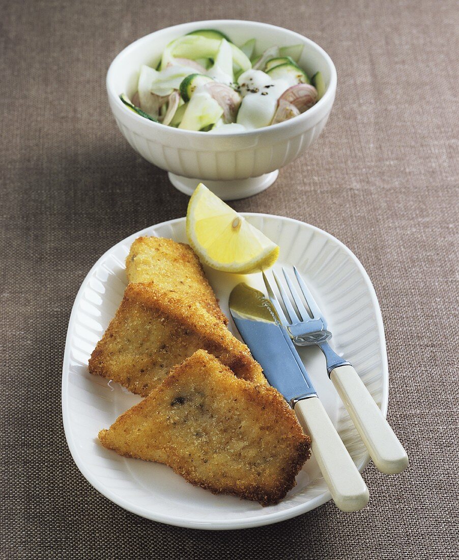 Breaded fish fillets with courgette and cucumber salad