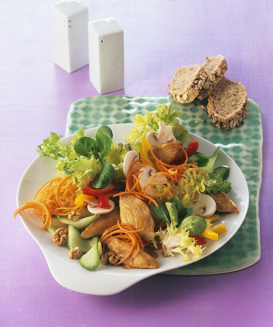 Mixed salad with chicken breast fillet and walnuts