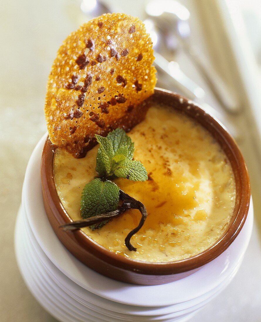 Catalan cream in a terracotta bowl with wafer