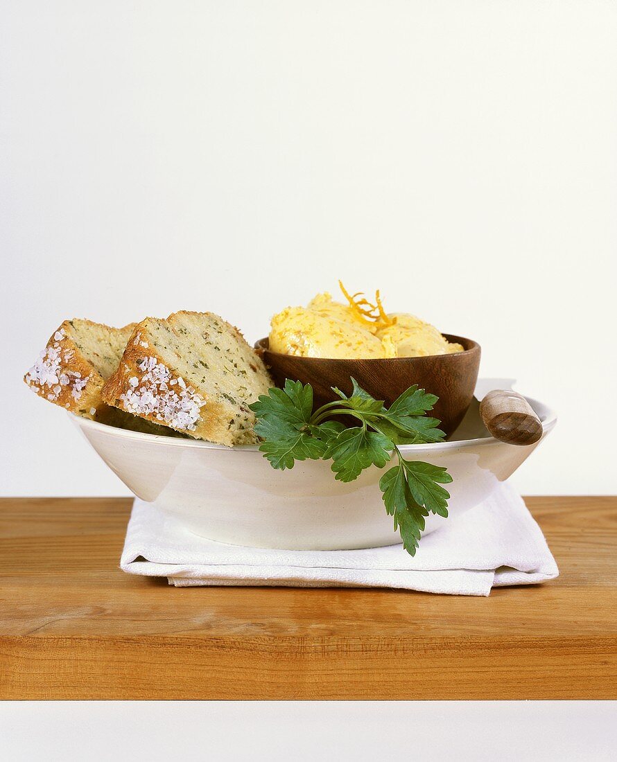 Herb bread with orange cheese spread in a dish