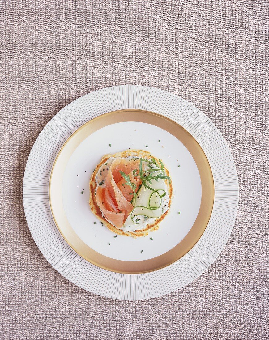 Pancake topped with chive spread, smoked salmon & cucumber
