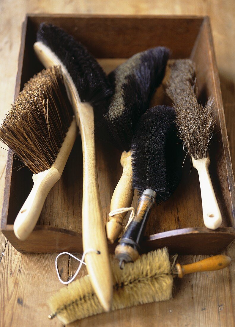 Assorted brushes in a wooden box