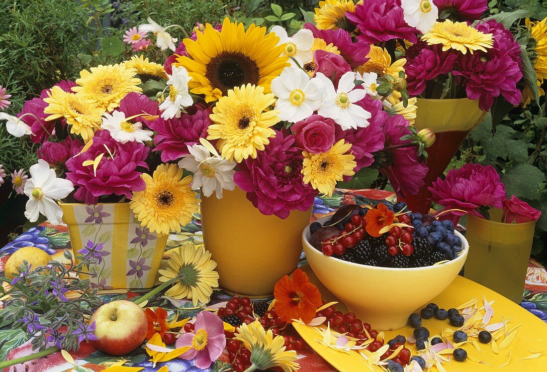 Pots of flowers and fresh berries out of doors