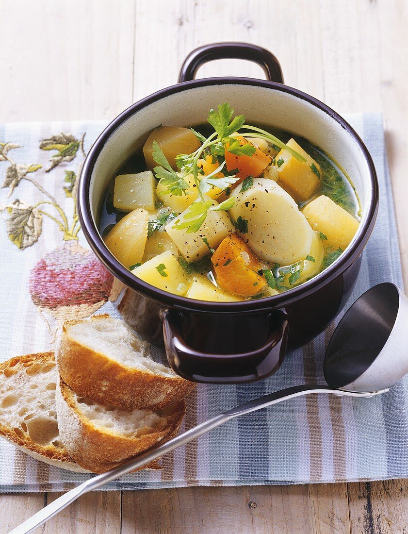 Potatoes and root vegetables in 'sour' stock with baguette