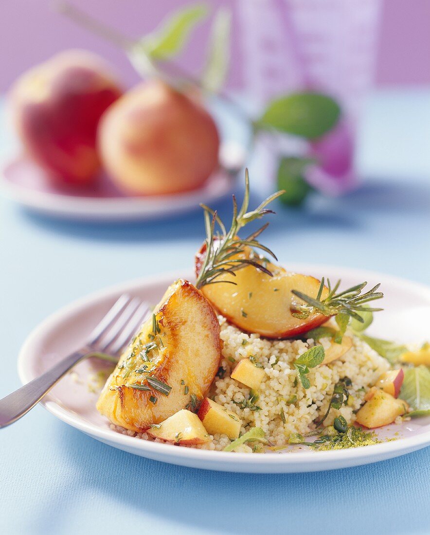 Roasted peaches with rosemary on couscous