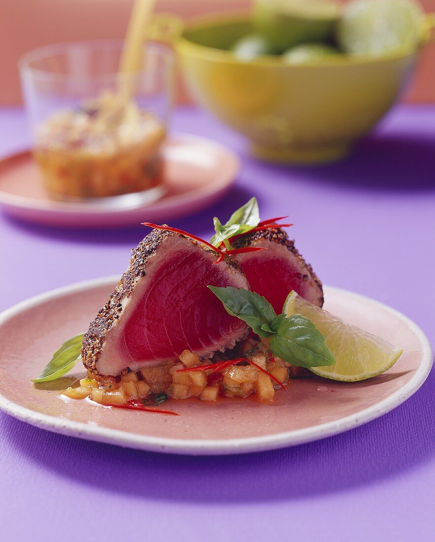 Fried tuna in pepper crust on melon salsa